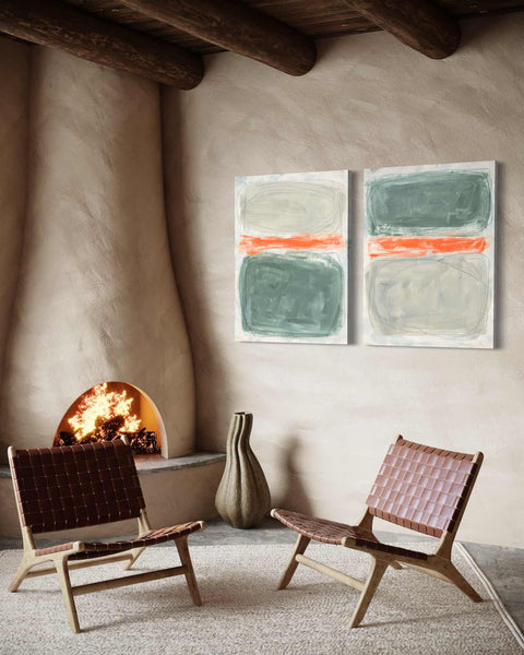 a couple of chairs sitting in front of a fire place