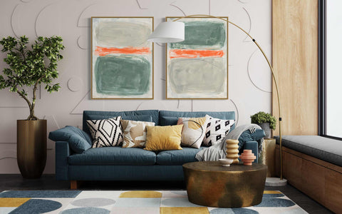 a living room with a blue couch and two paintings on the wall