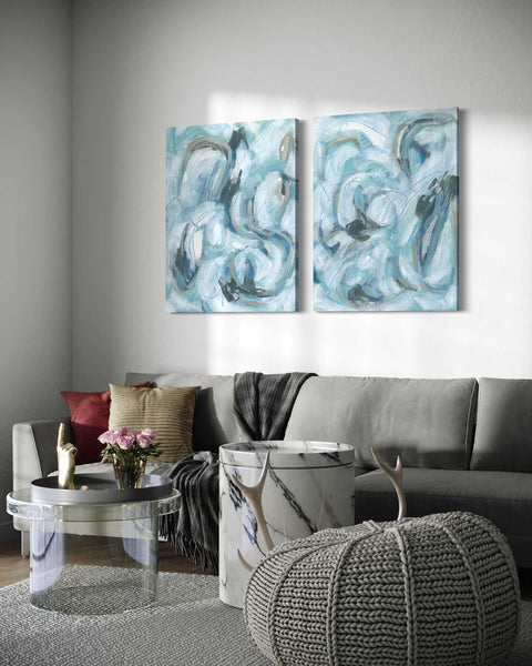 a living room with two paintings on the wall