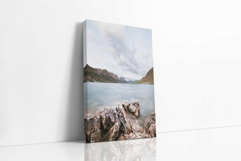 a painting on a wall of a lake with mountains in the background