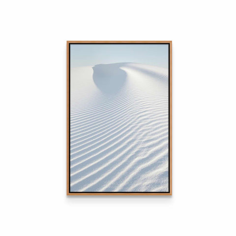 a framed photograph of a white sand dune