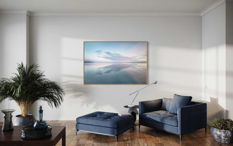 a living room filled with furniture and a painting on the wall