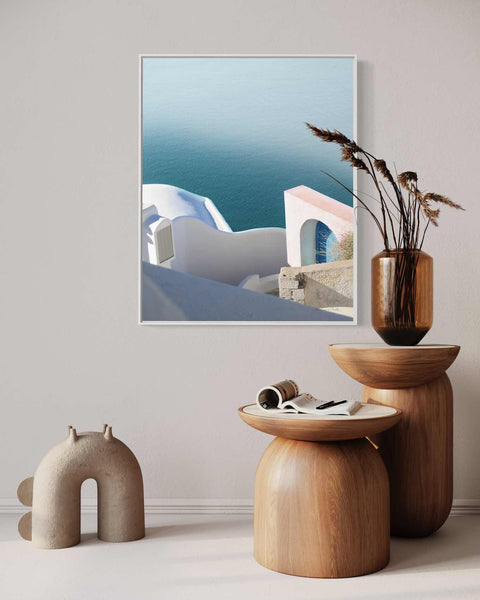 a picture of a white building with a blue ocean in the background