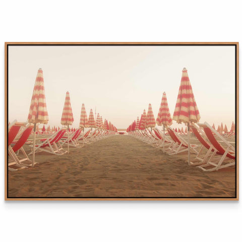 a row of beach chairs sitting on top of a sandy beach