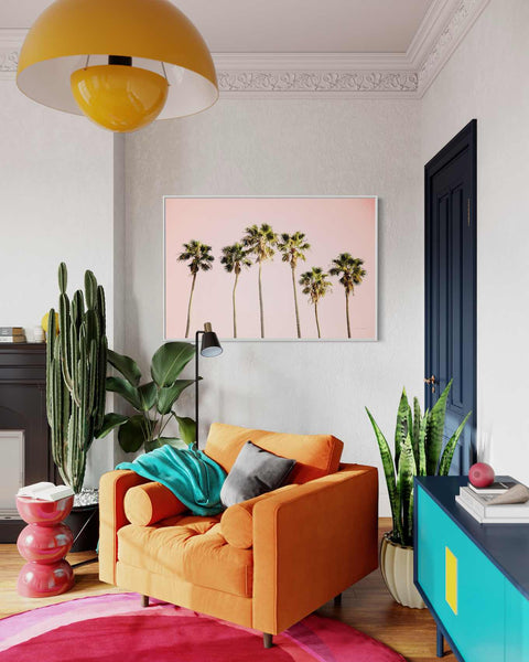 a living room filled with furniture and a painting on the wall