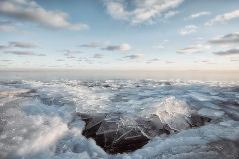 a large amount of ice floating on top of a body of water
