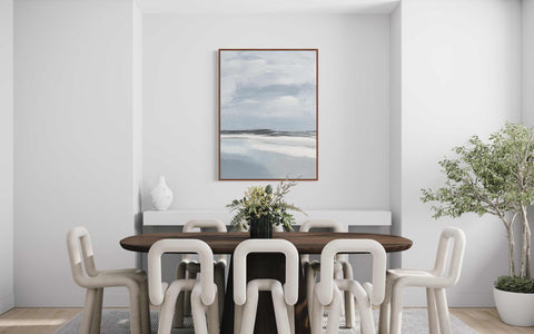a dining room table with white chairs and a painting on the wall