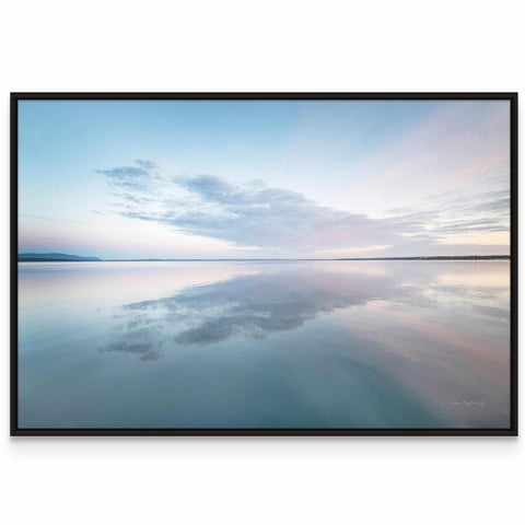 a picture of the sky and water reflecting the clouds