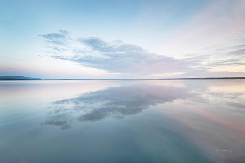 a large body of water sitting under a cloudy sky