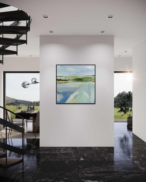 a painting hanging on a wall next to a staircase