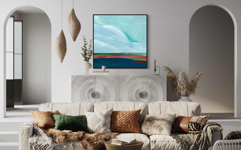 a living room filled with furniture and a painting on the wall