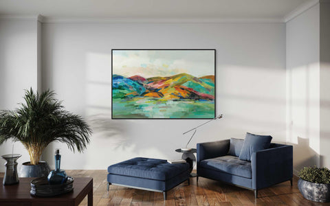 a living room with a blue chair and a painting on the wall
