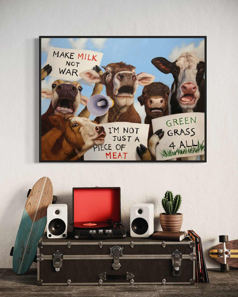 a group of cows holding signs on a wall