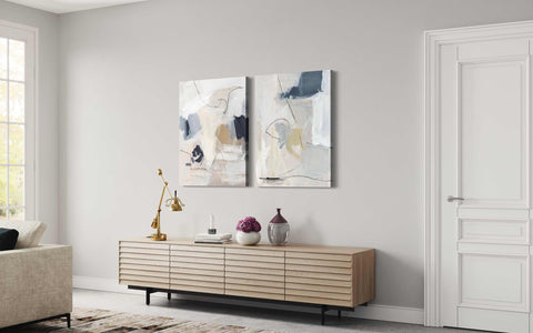 a living room with two paintings on the wall