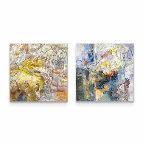 a couple of paintings sitting on top of a white wall