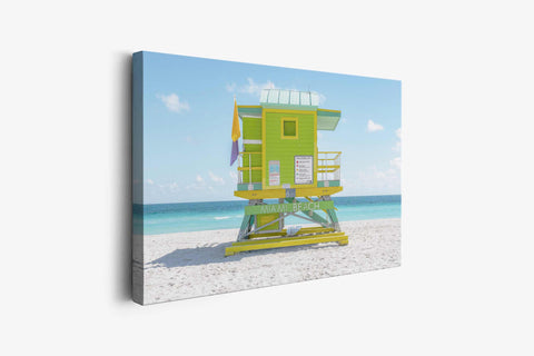 a lifeguard tower on a beach with a blue sky in the background