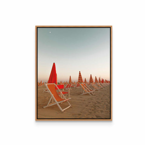 a row of beach chairs sitting on top of a sandy beach