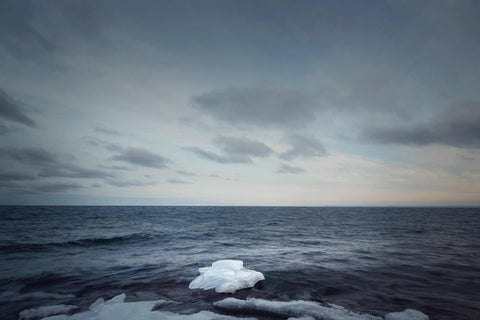 an iceberg floating on top of a body of water