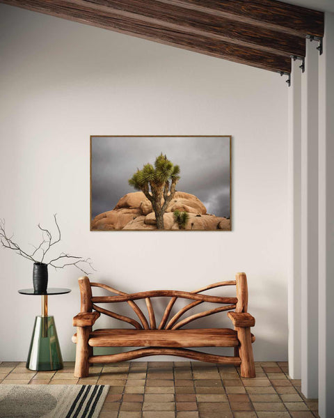 a bench in a room with a painting on the wall