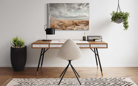 a desk with a chair and a potted plant